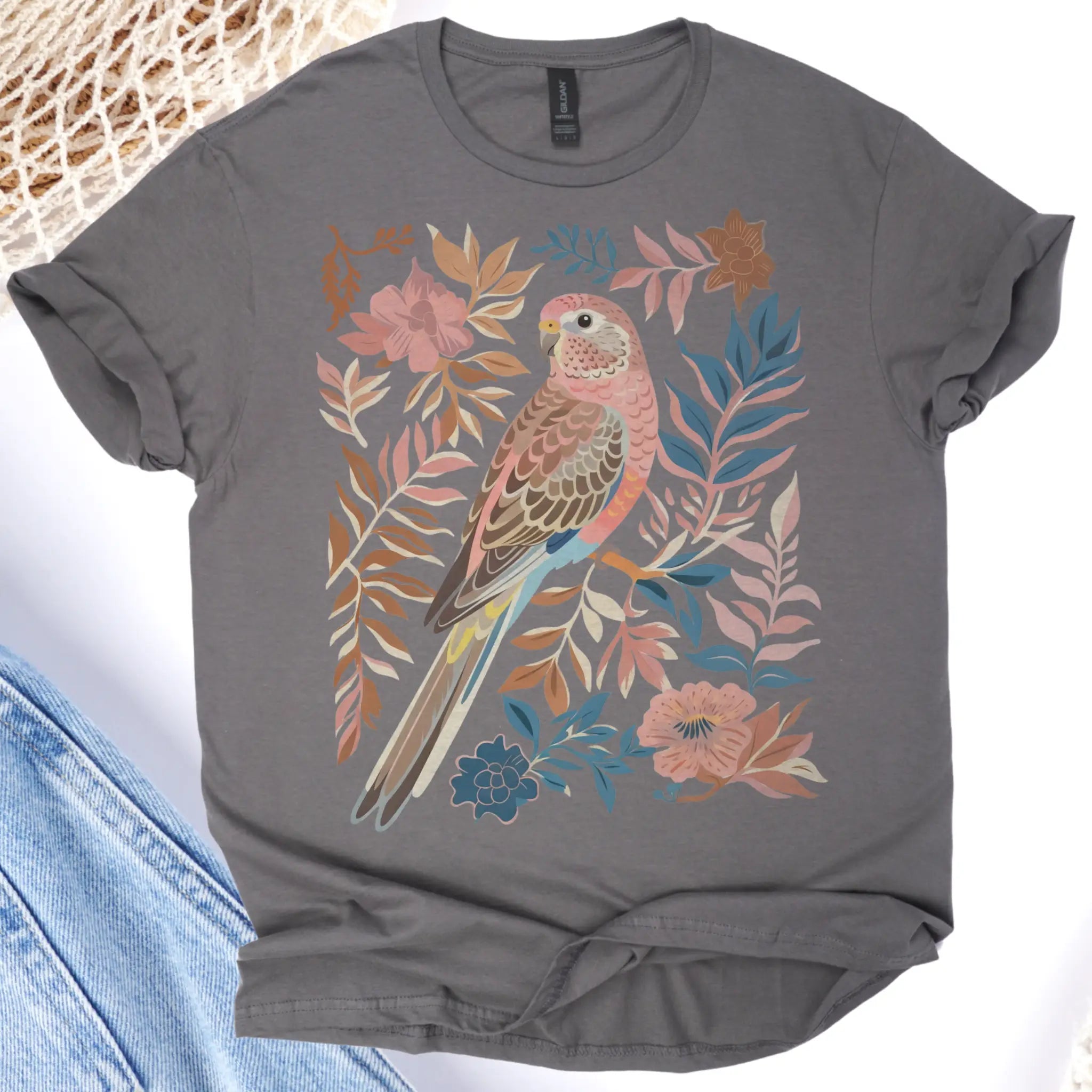 Gray t-shirt with a colorful parrot and floral design on a light background