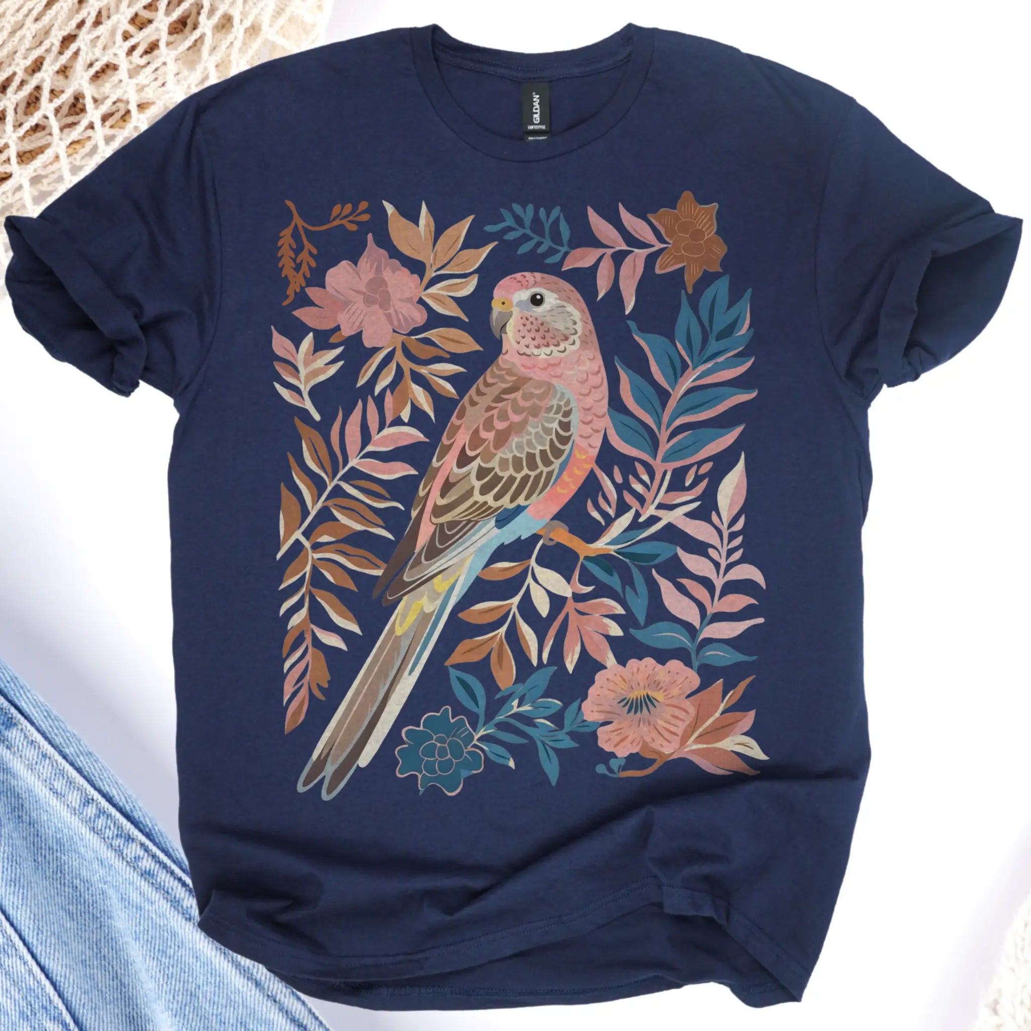 Navy blue t-shirt with a colorful bird and floral design on a white background