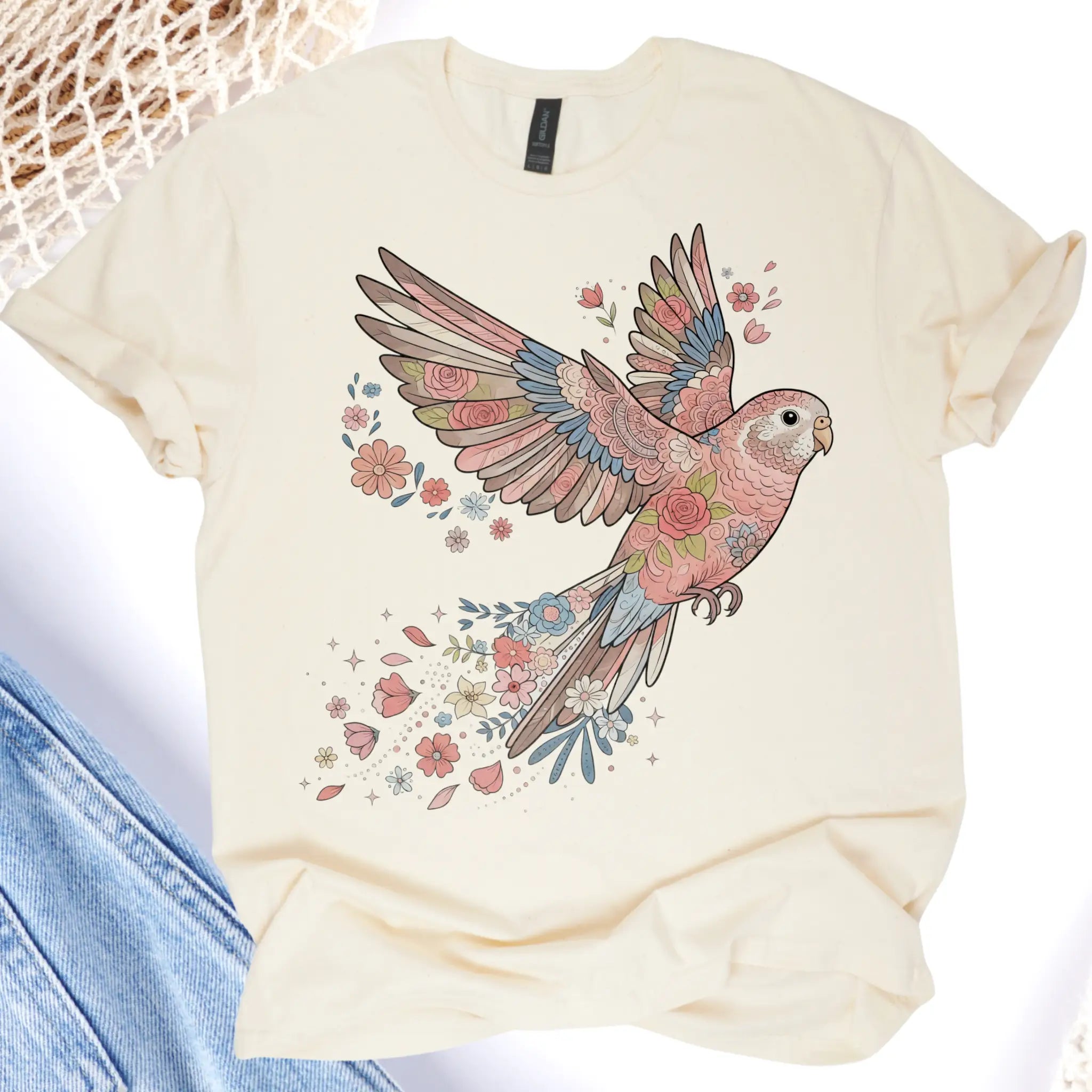 Beige t-shirt with a colorful parrot design on a white background