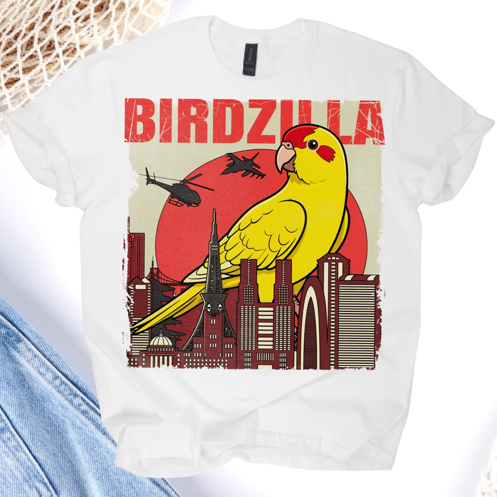White t-shirt with a colorful graphic of a parrot and cityscape, labeled 'BIRDZILLA'.